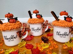 three coffee mugs decorated with thanksgiving decorations