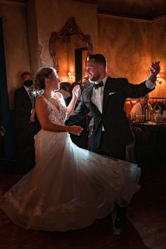 a bride and groom are dancing together at their wedding reception