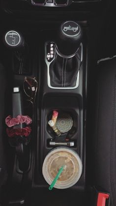 the interior of a car is neatly organized with items such as cups, bowls and spoons