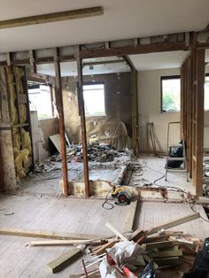 an unfinished room with wood flooring and walls that have been torn off from the house