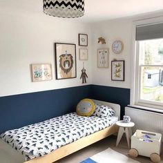 a child's bedroom with blue and white walls