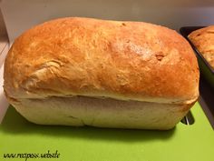 two loafs of bread sitting on top of a green counter