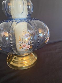 an ornate glass vase sitting on top of a table