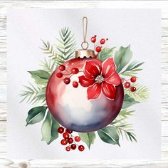 a watercolor christmas ornament with red flowers and green leaves on a white wooden background