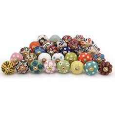 a pile of colorful beads sitting on top of each other in front of a white background