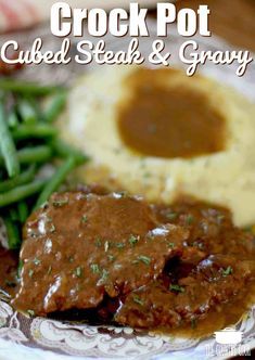 a close up of a plate of food with meat and gravy on it