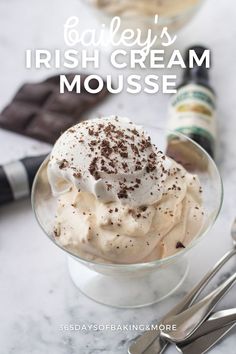 an ice cream dessert in a glass bowl with whipped cream and chocolate sprinkles