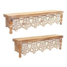 two wooden shelfs with carved designs on the top and bottom, one in white