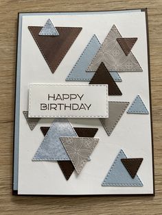 a happy birthday card with triangles on it