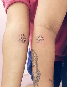 two people with matching tattoos on their arms