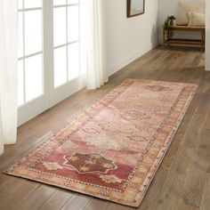 an area rug on the floor in front of a window