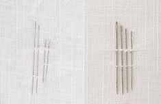 two different types of knitting needles next to each other on a white and beige surface