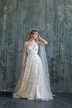 a woman in a wedding dress with a veil on her head