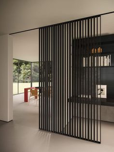 a room divider with black slats on the wall