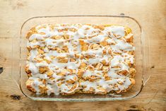 a casserole covered in white icing on top of a wooden table