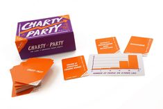 several orange and white cards sitting on top of each other next to a purple box