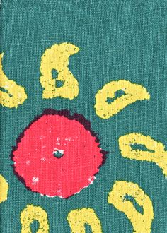 a green sweater with yellow letters and a red apple