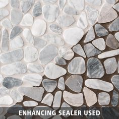 the words enhance sealer used on a stone floor with white and gray pebbles in it