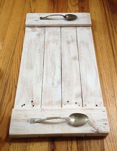 a wooden cutting board with spoons on it