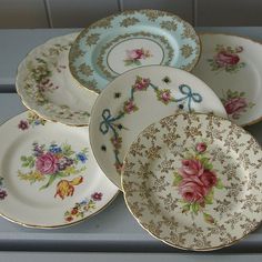 a bunch of plates sitting on top of a table next to each other in front of a tile wall