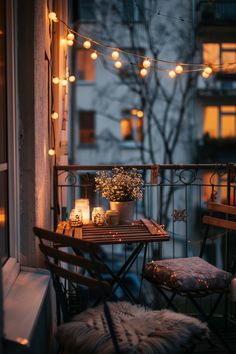 Cozy balcony with string lights, a small table set, and decorative candles, displaying a quaint outdoor decoration. Apartment Balcony Aesthetic, Fall Balcony, Balcony Decorating Ideas, Cozy Balcony, Balcony Chairs, Apartment Christmas