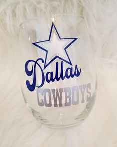 a wine glass with the word dallas written on it and a star in the middle