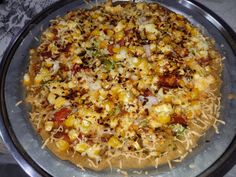 a pizza sitting on top of a pan covered in toppings