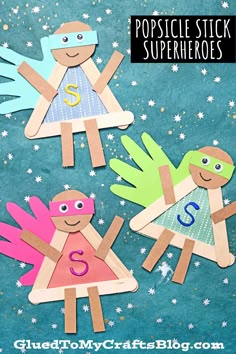 three popsicle stick superheros with the letter s on them and stars in the background