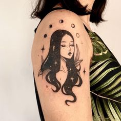 a woman's arm with a tattoo on it that has a girl and stars in the background