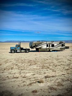 a truck towing a trailer in the desert