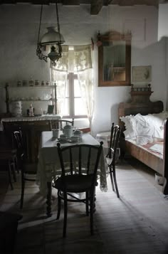 an old fashioned kitchen and dining room are seen in this image with sunlight streaming through the window