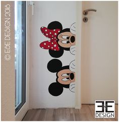 an image of mickey and minnie mouse wall decals on the door to a room