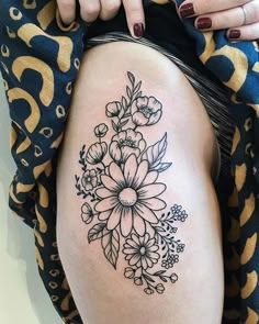 a woman's thigh with flowers on it