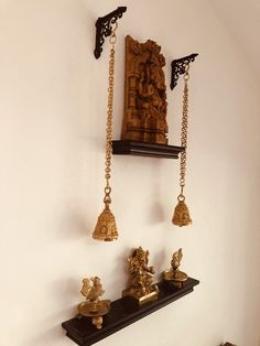 there are many ornaments hanging on the wall in this room, including bells and buddha figurines