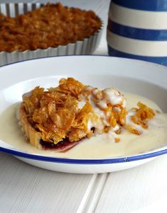 a white plate topped with food next to muffins