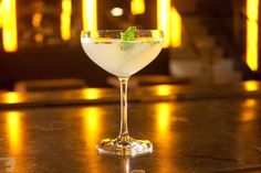 a close up of a drink in a glass on a table