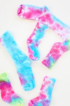 three pairs of socks with colorful tie dye on them