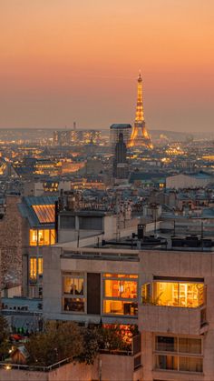 the eiffel tower is lit up at night