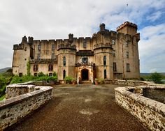 an old castle with a stone walkway leading to it