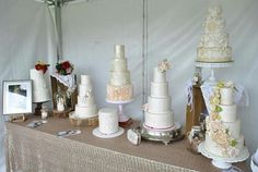 a table topped with lots of different types of cakes