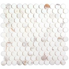 a white marble mosaic tile with circles on the bottom and one circle in the middle