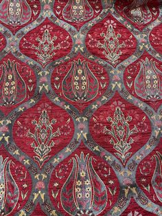 a red and grey area rug with an intricate design