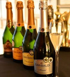 several bottles and glasses of wine on a table