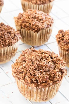 chocolate cupcakes cooling on a wire rack with other muffins in the background