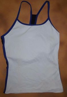 This is new with the original SAMPLE hang tag from Body Wrappers, 8462. This is a pullover camisole top with a racer back. The color is white with royal blue and black detail.  The size is a medium adult, and it is bodice lined in white.  Please refer to the measurement guide provided with the pictures to confirm a good fit. I have listed it with defects because of a dark smudge on the right side, see close up picture.  This item belonged to my Body Wrappers sales rep, and has not Sporty Tank Camisole For Gym, Sporty Tank Camisole For Workout, Sporty Workout Tank Camisole, Sports Stretch Camisole Top, Sports Tank Camisole, Stretch Sports Camisole Top, Sporty Gym Camisole With Tank Straps, Sporty Racerback Camisole For Sports, Athleisure Tank Strap Camisole For Sports