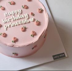 a birthday cake with pink frosting and roses on it