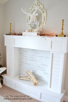 a white fireplace with christmas decorations on top