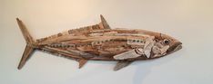 a fish made out of wood sticks on a wall