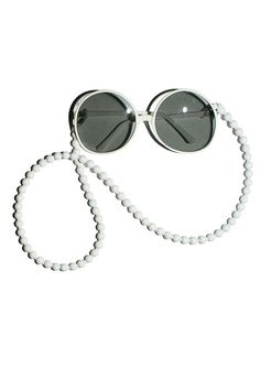 Chic glasses chain in 10mm wooden beads on a matching elastic cord with rubber loops to fit any pair of sunglasses or eyeglasses. 29" total length. Available in white, dark blue, and black. Adjustable White Glasses Chains With Round Beads, Trendy White Glasses Chains, Adjustable Single Strand White Glasses Chain, Dress Up Closet, Chic Glasses, Modern Accessories, Glasses Chain, Sunglasses & Glasses, Blue And Black