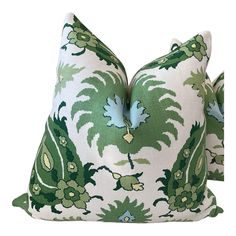 two green and white pillows with large leaves on the front, one is made out of fabric